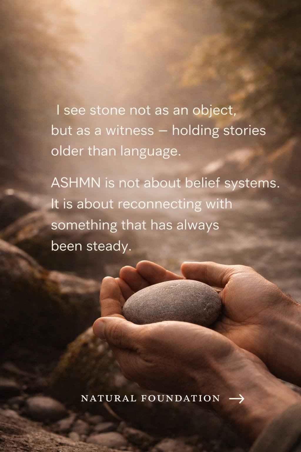 Hands holding an ASHMN stone — a witness holding stories older than language